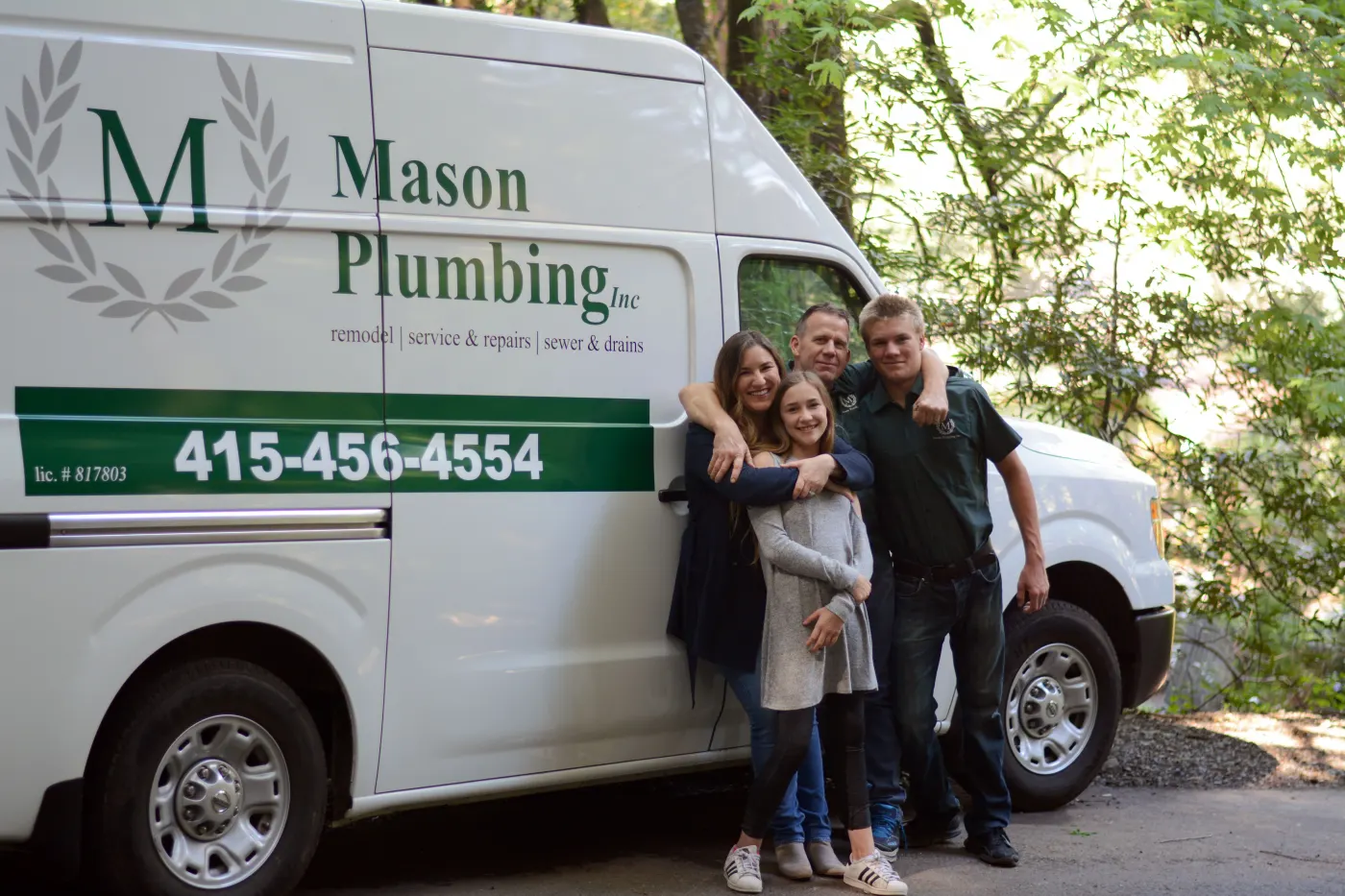 Members of the Mason family together beside a Mason Plumbing van