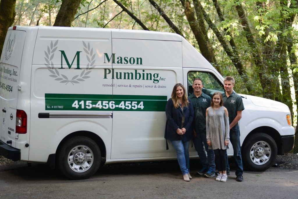 The Mason family beside their company van